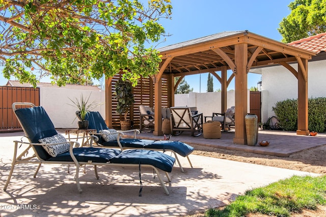 view of patio with a gazebo and fence