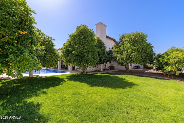 view of green lawn featuring an outdoor pool