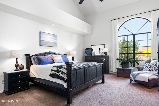 carpeted bedroom featuring ceiling fan and high vaulted ceiling