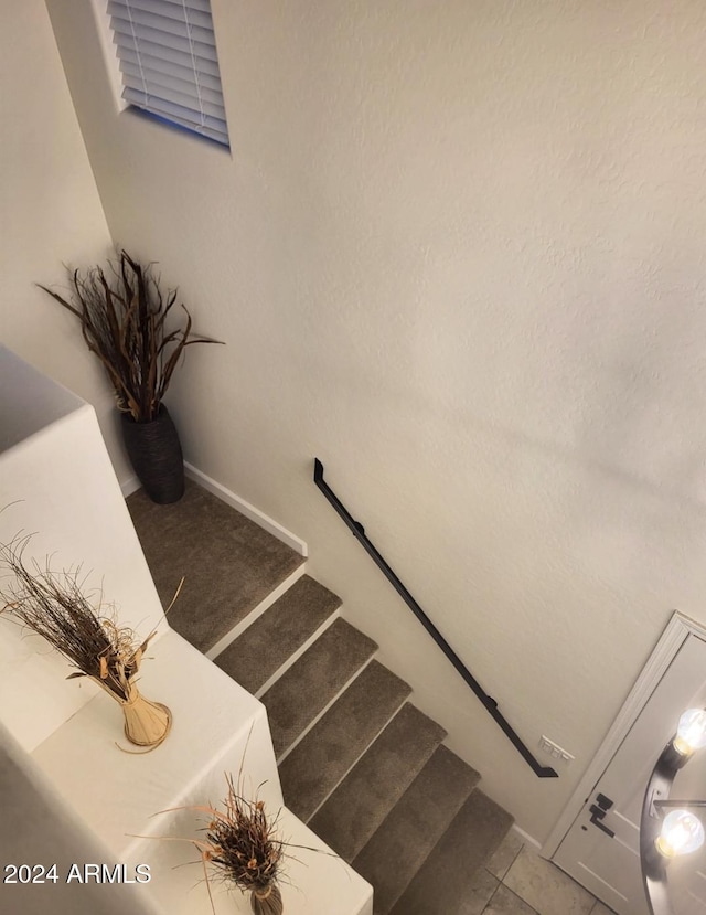 staircase featuring tile patterned flooring