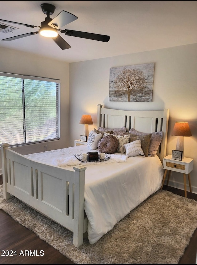 bedroom with ceiling fan and dark wood-type flooring