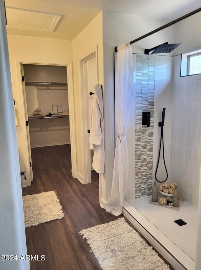 bathroom with hardwood / wood-style floors and a shower with shower curtain