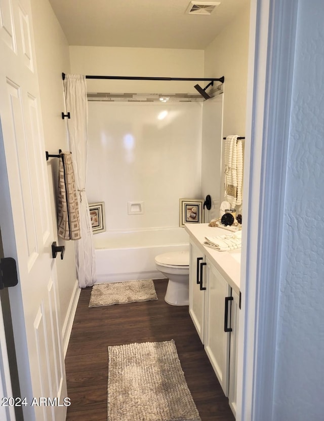 full bathroom featuring vanity, toilet, wood-type flooring, and shower / tub combo