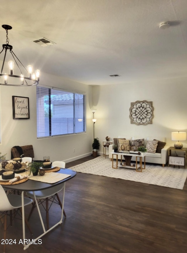 living room with dark hardwood / wood-style flooring and a chandelier