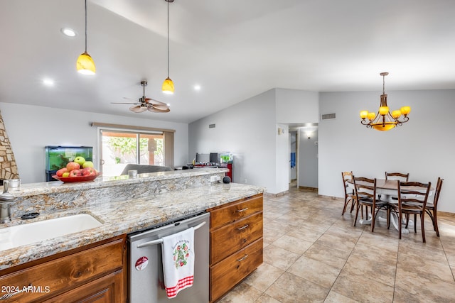 kitchen featuring lofted ceiling, dishwasher, light stone counters, and hanging light fixtures