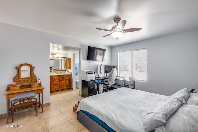 bedroom featuring ensuite bathroom, light tile patterned floors, and ceiling fan