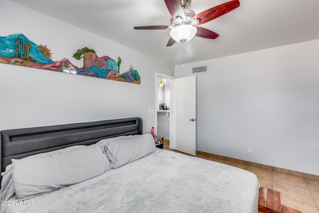 tiled bedroom featuring ceiling fan