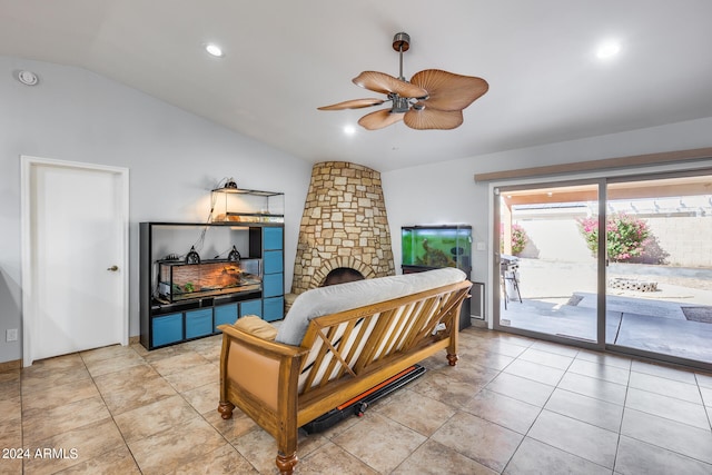 sitting room with light tile patterned floors, ceiling fan, lofted ceiling, and a fireplace