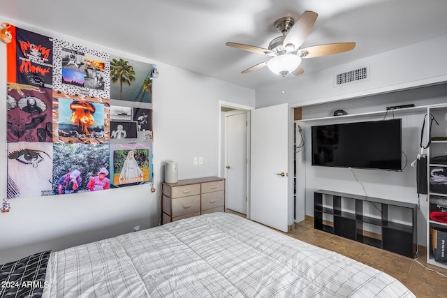 tiled bedroom featuring a closet and ceiling fan