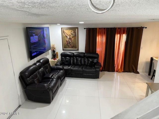 tiled home theater room with a textured ceiling