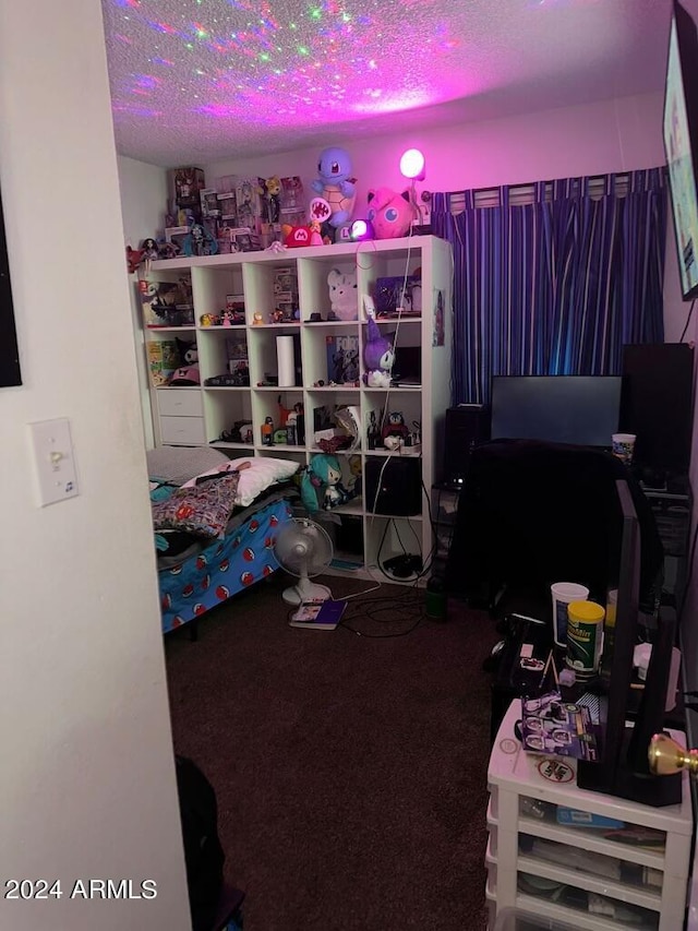 bedroom featuring carpet flooring and a textured ceiling