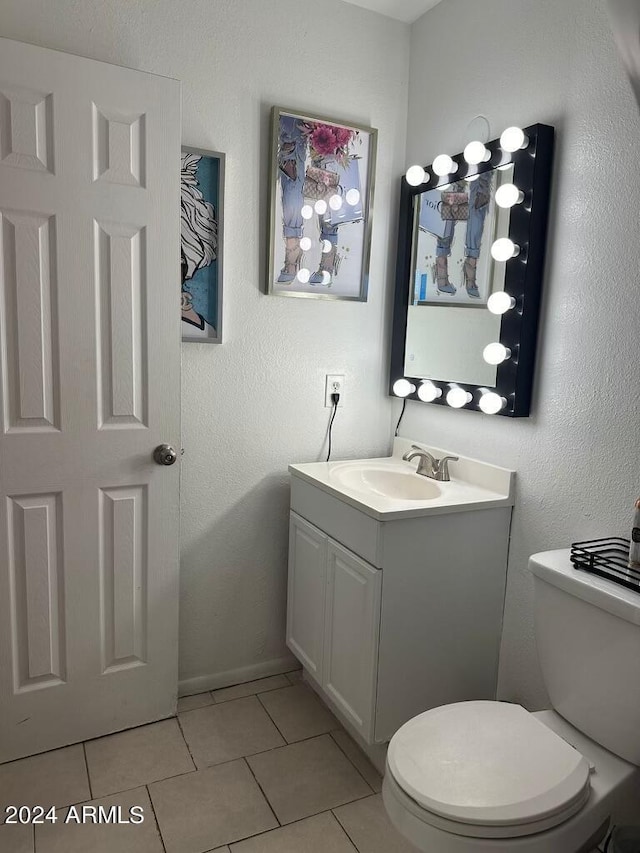 bathroom with tile patterned floors, vanity, and toilet