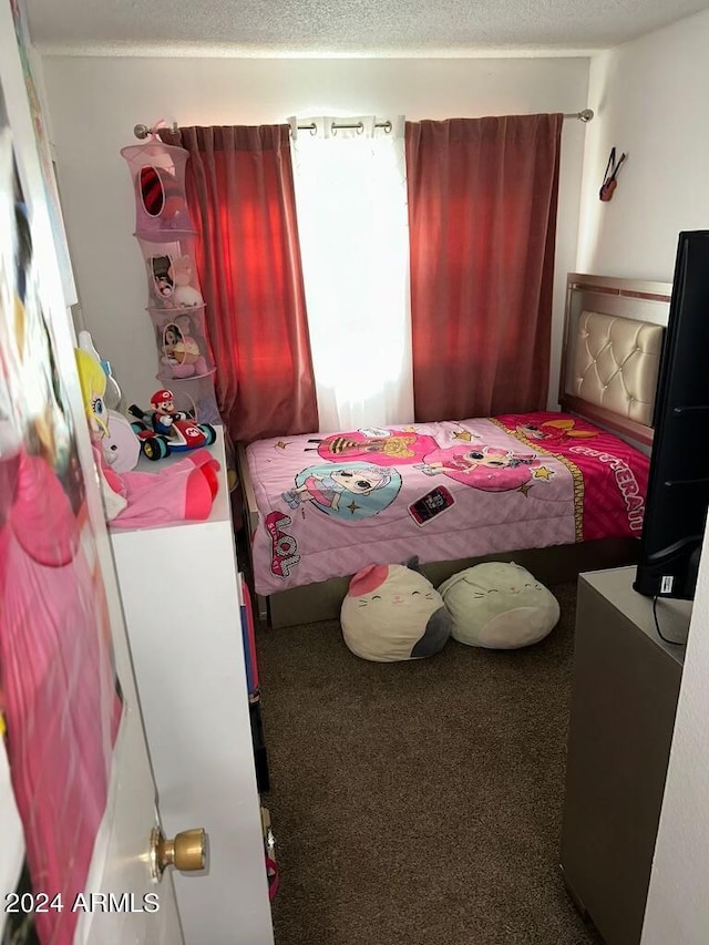 carpeted bedroom with a textured ceiling