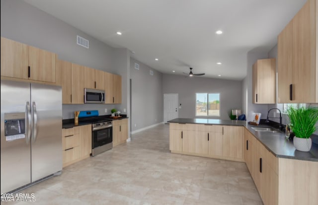 kitchen with sink, ceiling fan, appliances with stainless steel finishes, light brown cabinetry, and kitchen peninsula