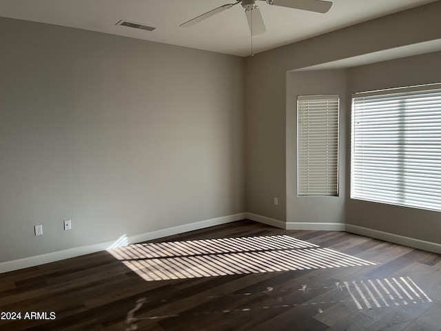 unfurnished room featuring ceiling fan and dark hardwood / wood-style flooring