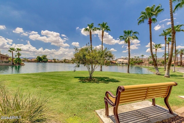 view of community featuring a water view and a lawn