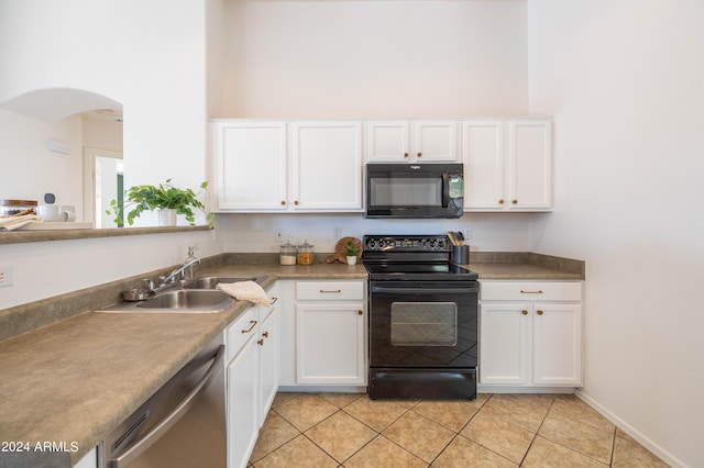 kitchen featuring white cabinets, light tile patterned floors, sink, and black appliances