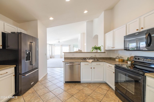 kitchen featuring sink, light tile patterned floors, white cabinets, and black appliances