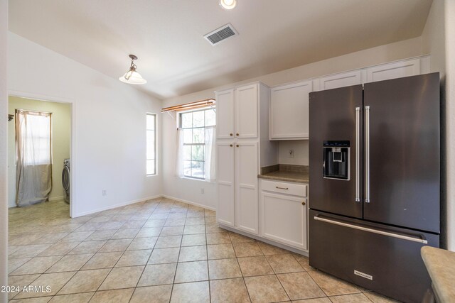 kitchen with light tile patterned floors, sink, black appliances, and a high ceiling