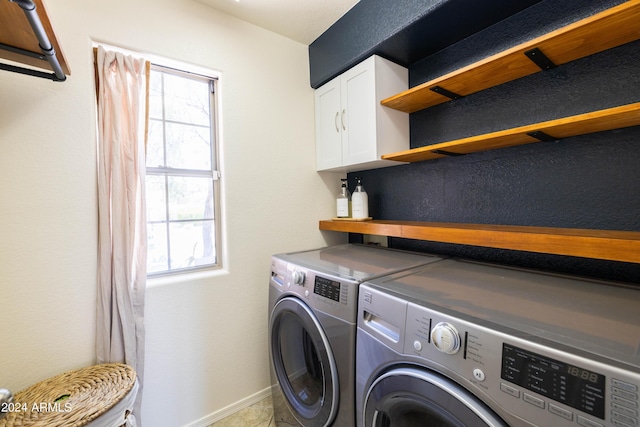 washroom with cabinets and washer and clothes dryer