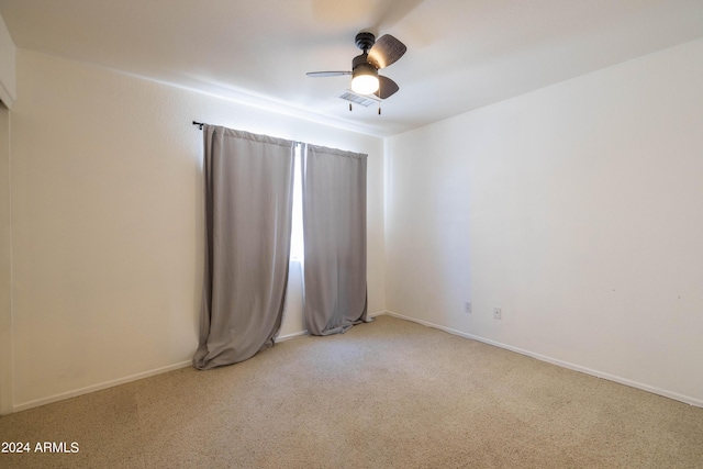 carpeted empty room featuring ceiling fan