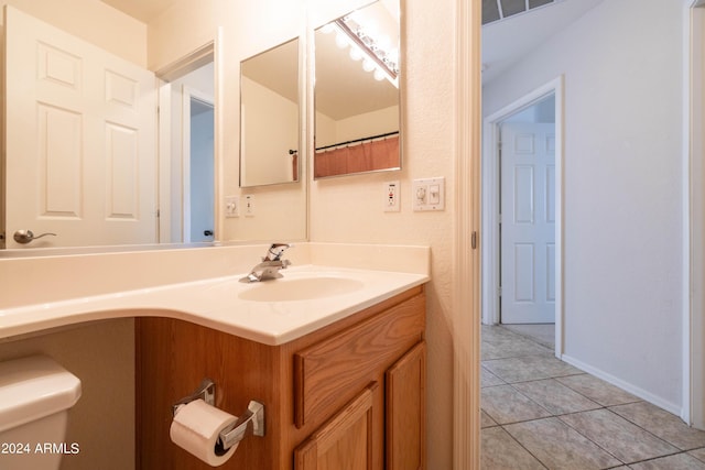 bathroom featuring vanity, toilet, and tile patterned flooring