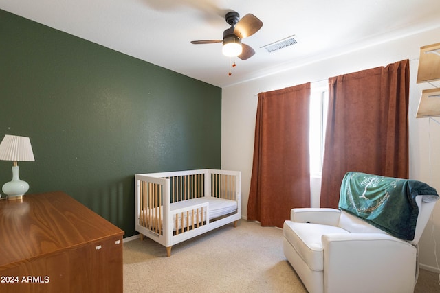 bedroom with light colored carpet and ceiling fan