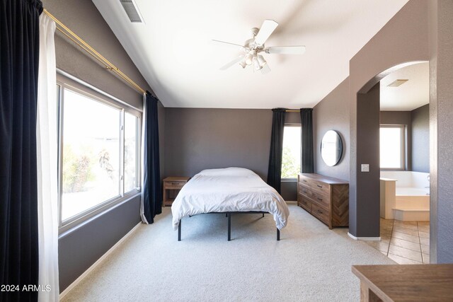 bedroom with ceiling fan, light carpet, and a crib