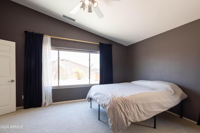 bedroom with lofted ceiling, light carpet, and ceiling fan