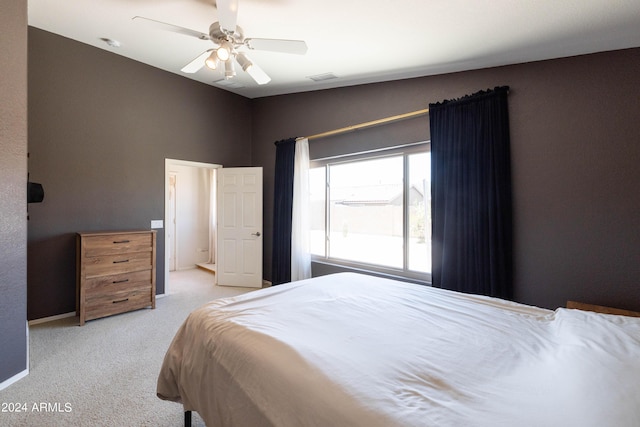 carpeted bedroom featuring lofted ceiling and ceiling fan