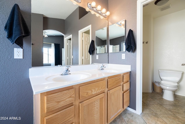 bathroom featuring vanity, tile patterned floors, and toilet