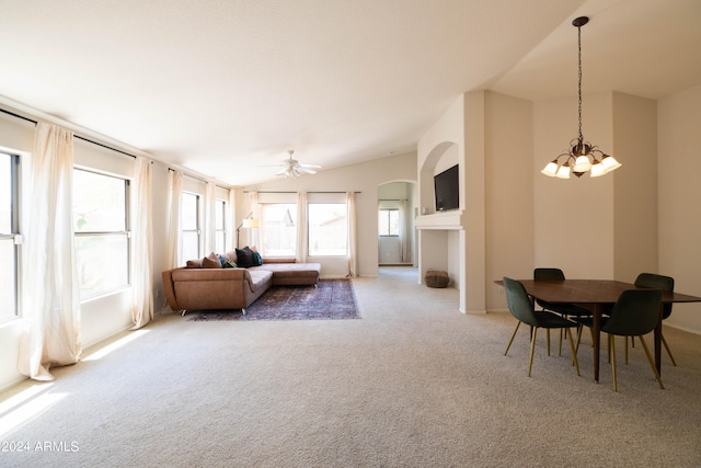 living room with ceiling fan with notable chandelier, lofted ceiling, and carpet floors