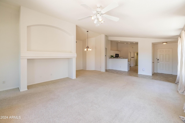 unfurnished living room with light carpet and ceiling fan with notable chandelier