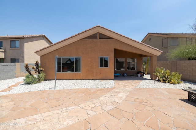 rear view of property featuring a patio