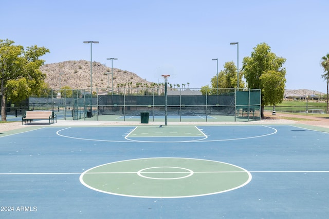 view of basketball court with a mountain view and tennis court