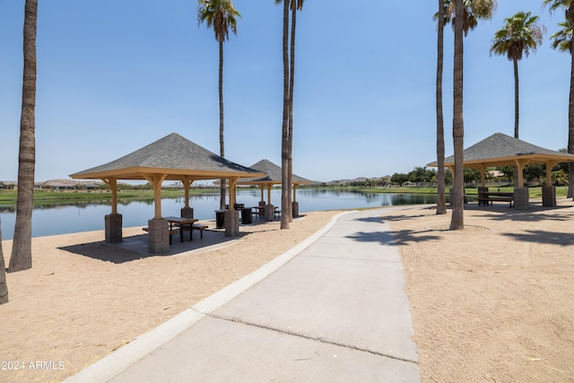 view of dock with a gazebo and a water view