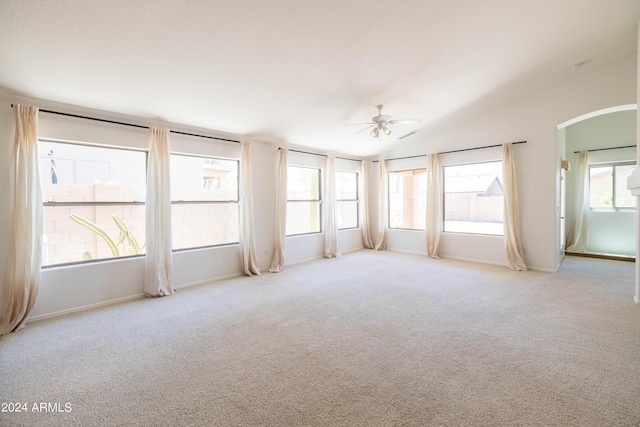 carpeted empty room featuring ceiling fan and lofted ceiling