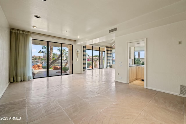 spare room with visible vents and baseboards