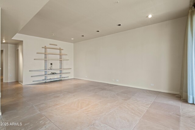 unfurnished room featuring recessed lighting and baseboards