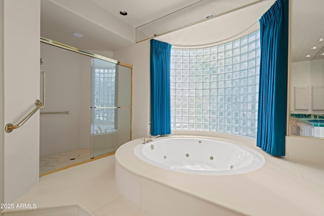 full bath with a tub with jets, plenty of natural light, and a shower stall