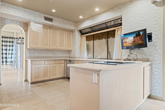 kitchen featuring arched walkways, recessed lighting, light countertops, visible vents, and wallpapered walls