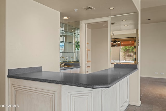 bar featuring recessed lighting, visible vents, a sink, and tile patterned floors