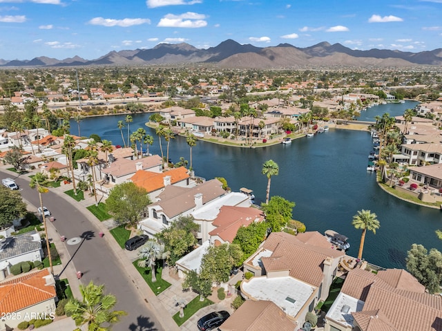 drone / aerial view with a residential view and a water and mountain view