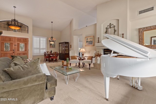 living area featuring lofted ceiling, carpet flooring, and visible vents