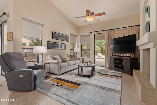 tiled living room with high vaulted ceiling and a ceiling fan