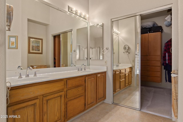 full bathroom featuring double vanity, a sink, and tile patterned floors