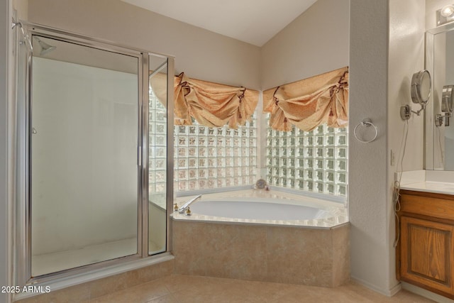 full bathroom with a stall shower, a garden tub, vanity, and a healthy amount of sunlight