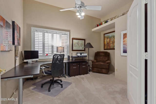 office space with light carpet and a ceiling fan