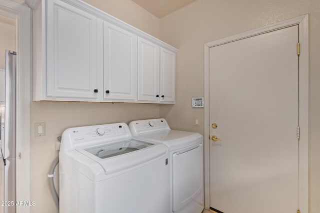 laundry room with cabinet space and washer and dryer