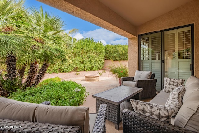 view of patio / terrace with an outdoor living space with a fire pit